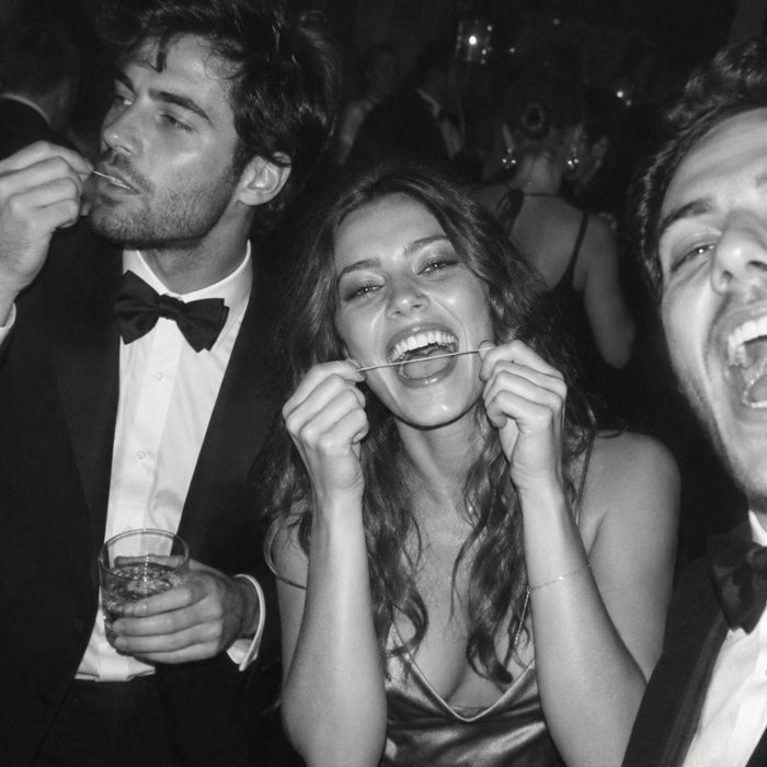 Friends flossing and laughing at a party